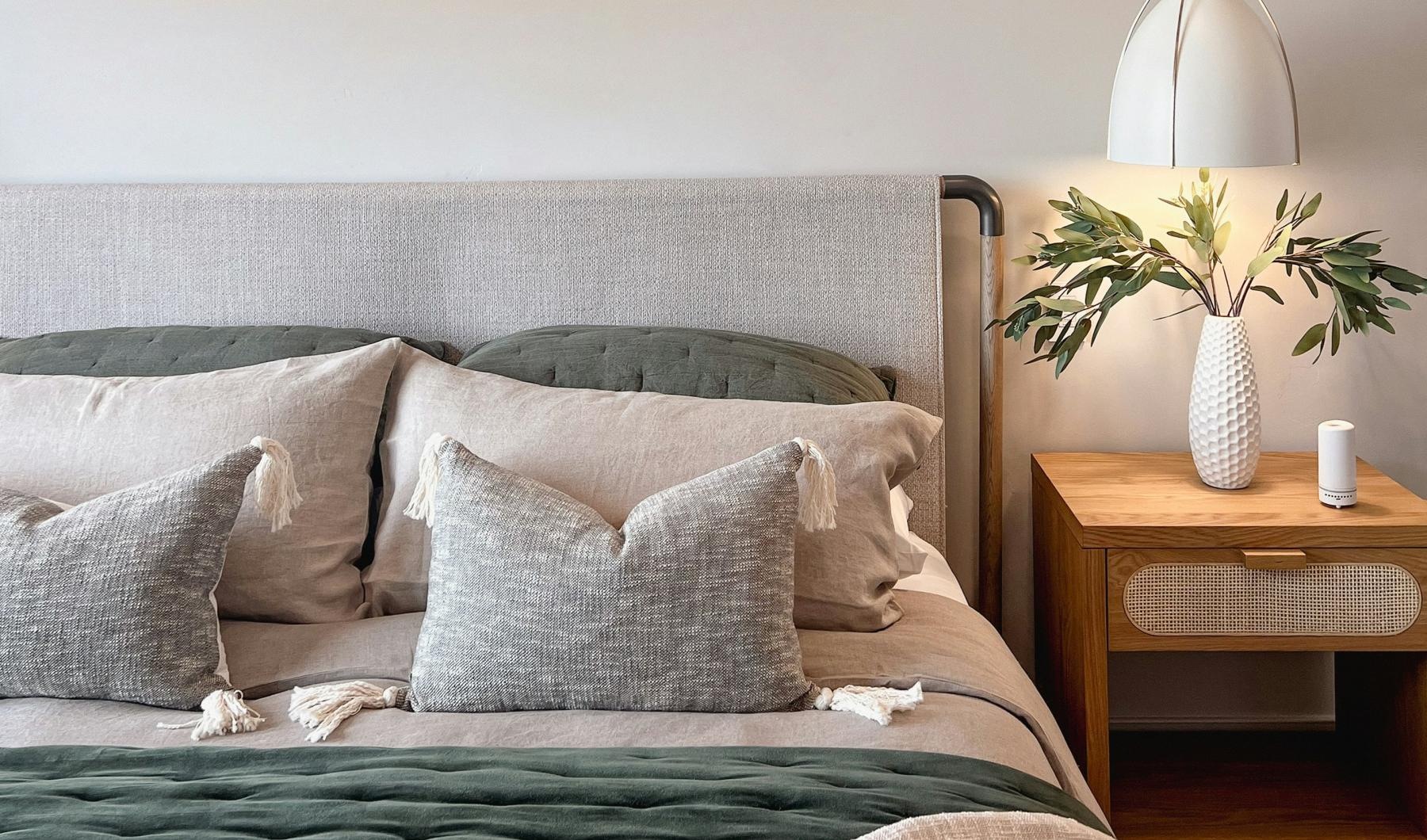 a bed with pillows and a lamp