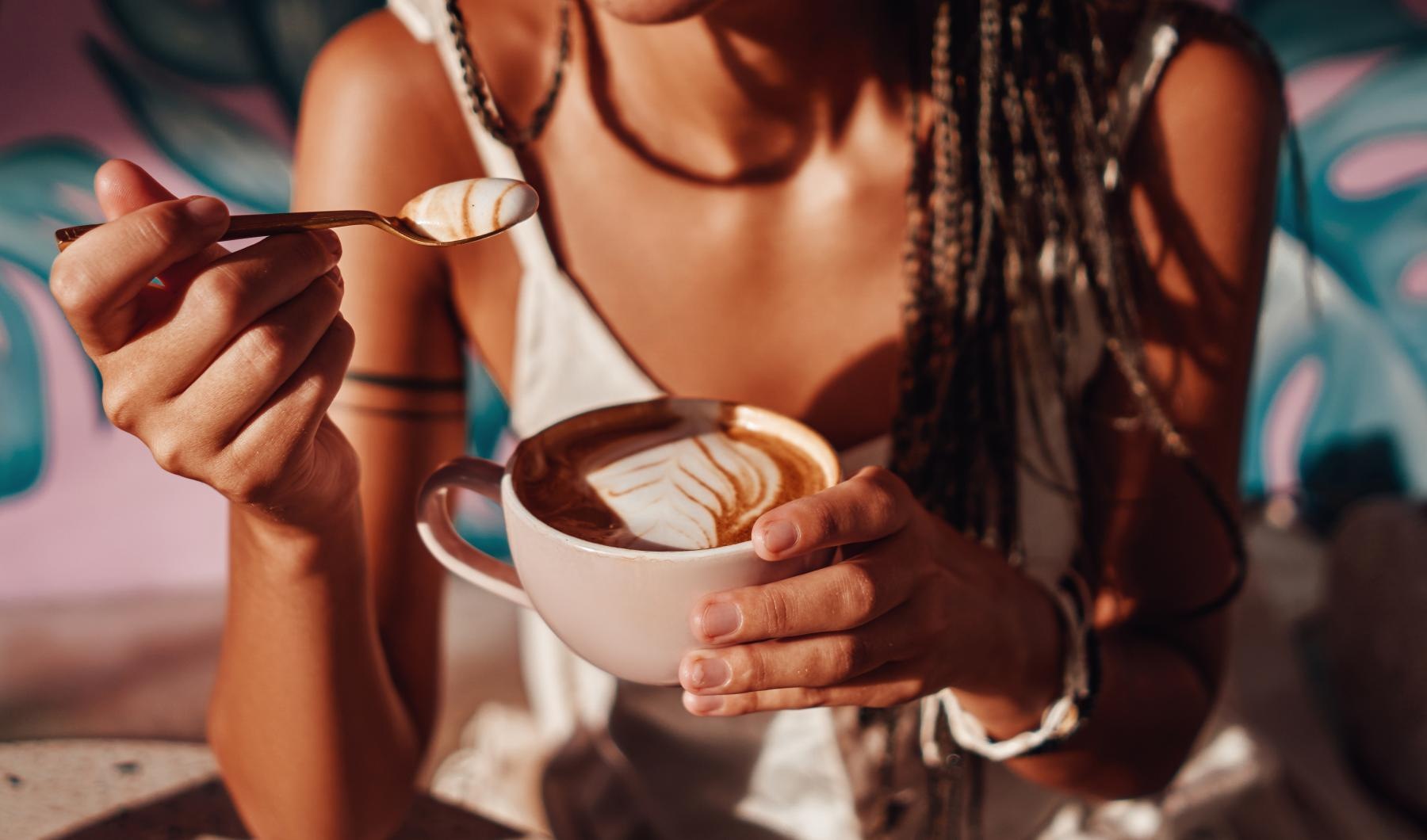 a woman eating a cup of coffee